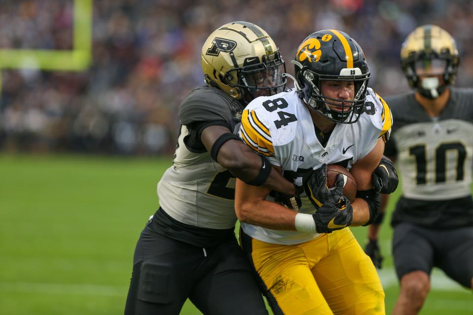 Purdue Boilermakers safety Sanoussi Kane (21) tries to tackle Iowa Hawkeyes tight end Sam LaPorta (84) before LaPorta scores a touchdown during the NCAA football game, Saturday, Nov. 5, 2022, at Ross-Ade Stadium in West Lafayette, Ind.