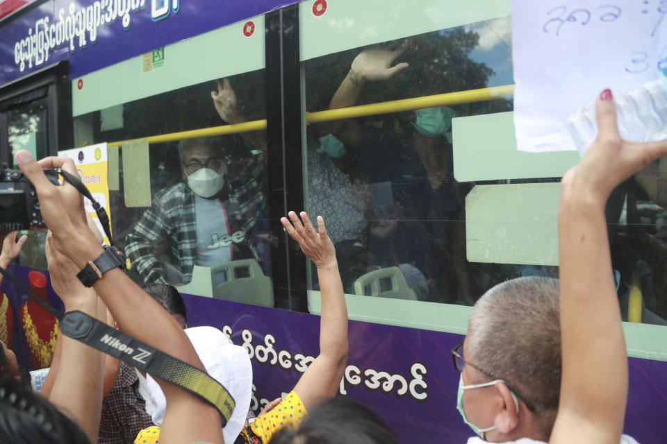 Detainees wave from a bus after a mass-prisoner release from the Insein Prison Tuesday, Oct. 19, 2021, in Yangon, Myanmar. Myanmar's government on Monday announced an amnesty for thousands of prisoners arrested for taking part in anti-government activities following February's seizure of power by the military. (AP Photo)