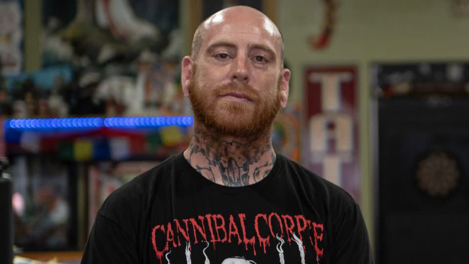 Tattoo artist James Walls poses for a portrait at his shop, Jackson Street Tattoo. After the shooting, he helped raise money for the victims' families. - Will Lanzoni/CNN