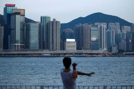 FILE PHOTO: A man excercises at Hung Hom Promenade in Hong Kong