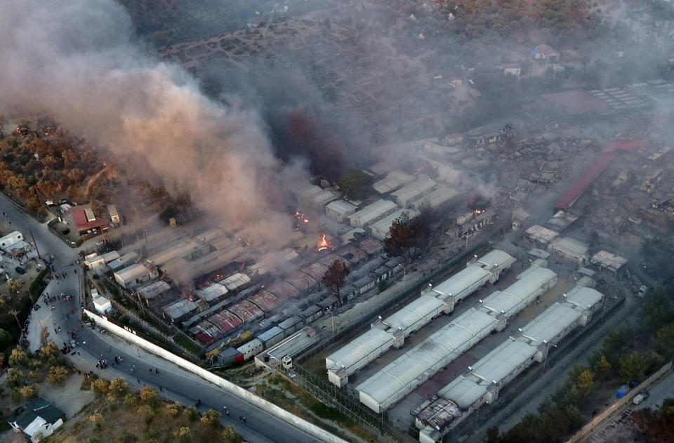 Image: Fire burns container houses and tents in the Moria refugee camp on the northeastern Aegean island of Lesbos, Greece (Panagiotis Balaskas / AP)