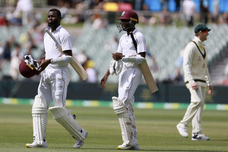 The West Indies batsmen Marquino Mindley, center, and Anderson Phillip, left, walks off after losing to Australia on the fourth day of their cricket test match in Adelaide, Sunday, Nov. 11, 2022. (AP Photo/James Elsby)