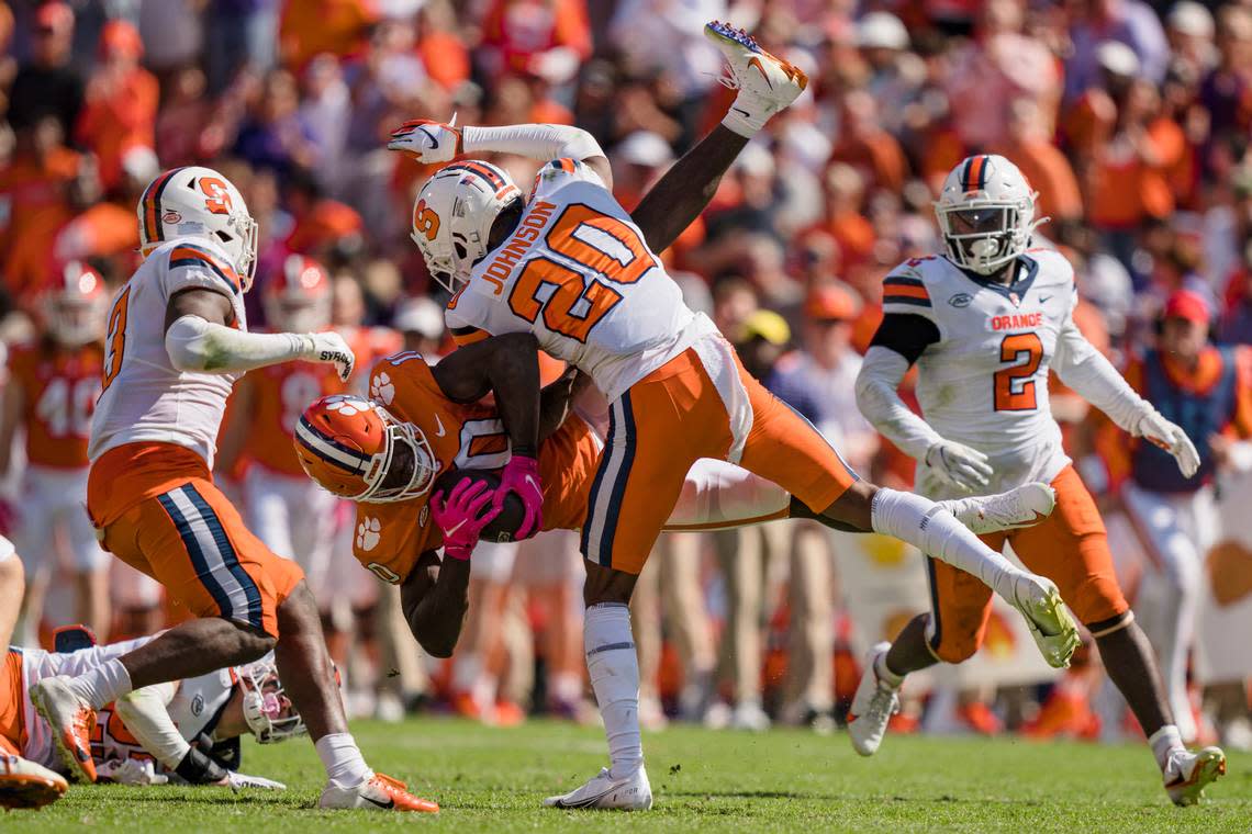 Syracuse defensive back Isaiah Johnson (20) tackles Clemson wide receiver Joseph Ngata (10) in the first half during an NCAA college football game on Saturday, Oct. 22, 2022, in Clemson, S.C. (AP Photo/Jacob Kupferman)