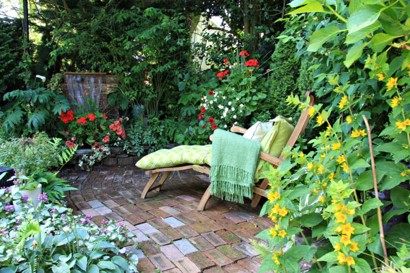 Comfortable lounge chair in a small private garden.