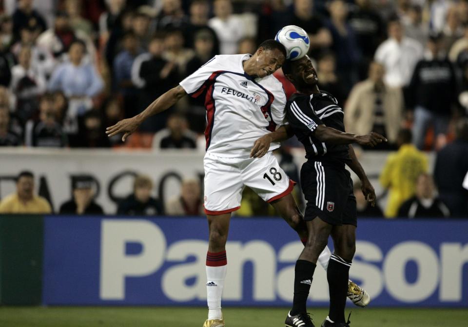 New England Revolution midfielder Khano Smith, left, and DC United forward Luciano Emilio attempt to head the ball during a game in May 2007 in Washington, D.C.