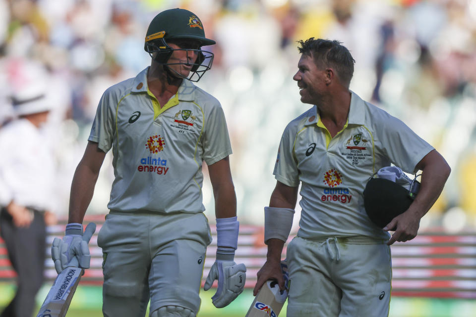 Australia's David Warner, right, and Marnus Labuschagne walk from the field at the end of play on day one of the second cricket test between South Africa and Australia at the Melbourne Cricket Ground, Australia, Monday, Dec. 26, 2022. (AP Photo/Asanka Brendon Ratnayake)