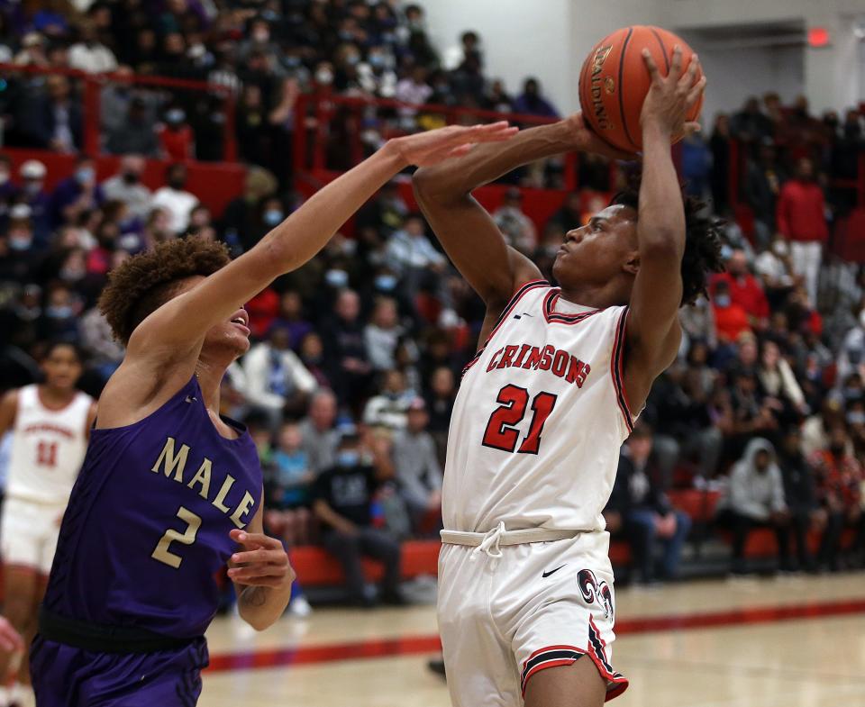 Manual’s Damone King gets the bucket against Male’s Demetrius White.  Feb. 11, 2022