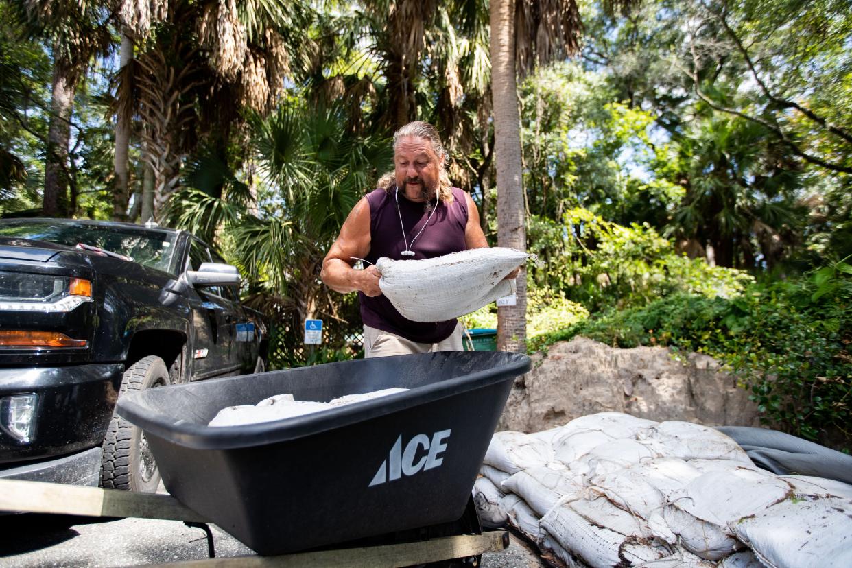 John Hines, owner of Sweet Magnolia Inn in St. Marks, Florida, prepares for Tropical Storm Idalia by placing sandbags in the doorways to his bed and breakfast on Monday, Aug. 28, 2023.