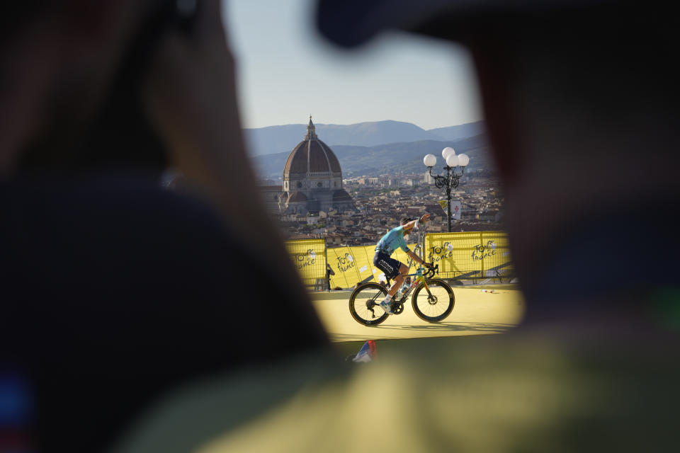 AP PHOTOS A race to capture the Tour de France before it flies by