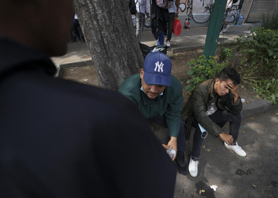 Venezuelan migrants wait for assistance outside of the Mexican Commission for Refugee Aid in Mexico City, Thursday, Oct. 20, 2022. This group of migrants interrupted their trek in Mexico City after the U.S. announced that Venezuelans who walk or swim across the border will be immediately returned to Mexico without the right to seek asylum. (AP Photo/Fernando Llano)