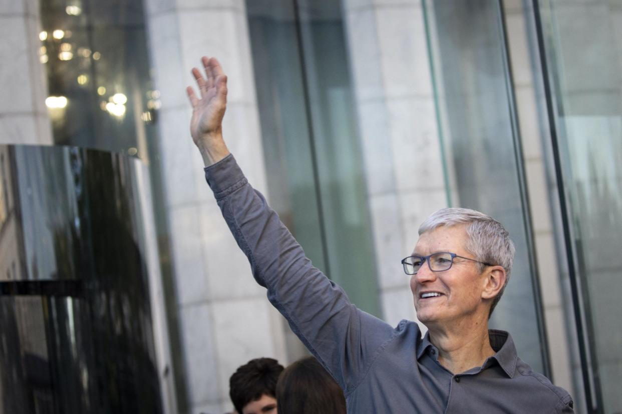 Apple CEO Tim Cook waves to customers before they enter Apple's flagship 5th Avenue store to purchase the new iPhone 11 on September 20, 2019 in New York City: Drew Angerer/Getty Images