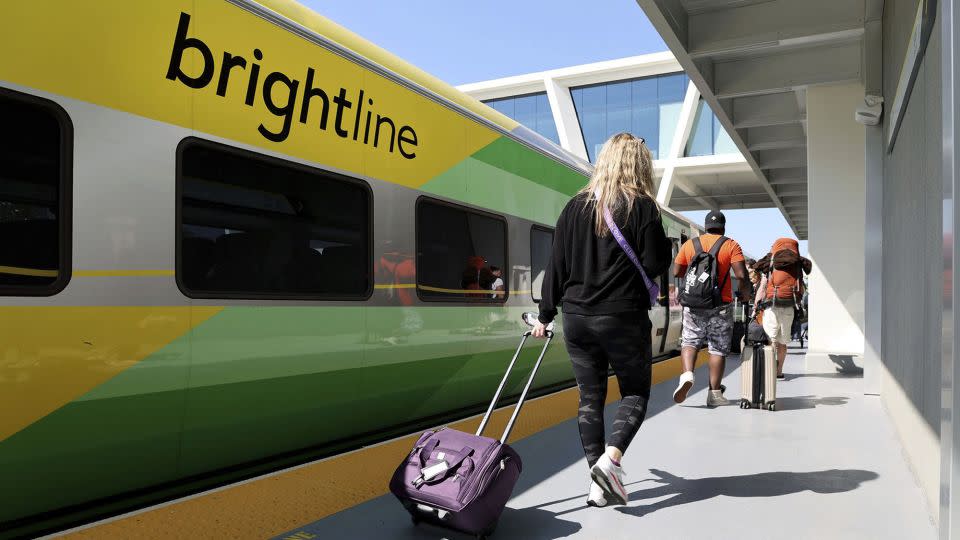 Passengers load a Brightline train to West Palm Beach at the Fort Lauderdale station on Feb. 27, 2023, in Florida. The privately owned high-speed rail network plans a Los Angeles to Las Vegas route. - Carline Jean/South Florida Sun Sentinel/Tribune News Service/Getty Images