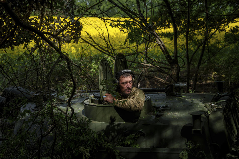 A Ukrainian soldier from the 57th Brigade waits for an order for his artillery vehicle to open fire on Russian positions at the front line in Ukraine’s Kharkiv region, Sunday, May 19, 2024. (AP Photo/Evgeniy Maloletka)