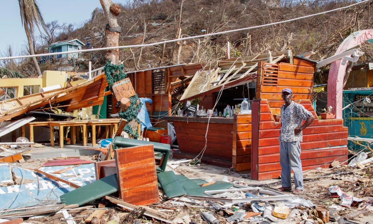 <span>A man stands by a destroyed business in Clifton, on the island of Union, which bore the brunt of the damage from Hurricane Beryl.</span><span>Photograph: Lucanus Ollivierre/AP</span>