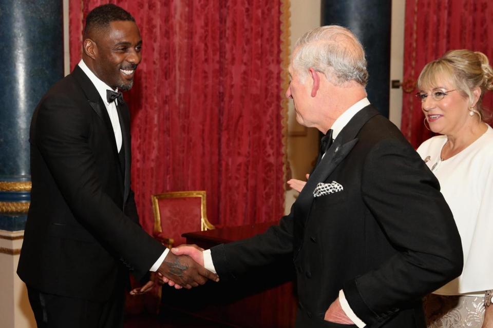 Idris Elba greets Prince Charles the Prince's Trust dinner at Buckingham Palace (PA)