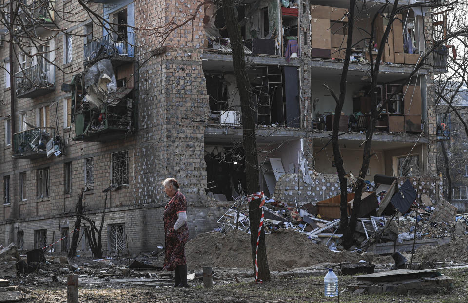 KYIV, UKRAINE - MARCH 28: A woman inspects at the site after an apartment hit by Russian shelling in Vinograd district of the capital Kyiv, Ukraine on March 28, 2022. (Photo by Metin Aktas/Anadolu Agency via Getty Images)