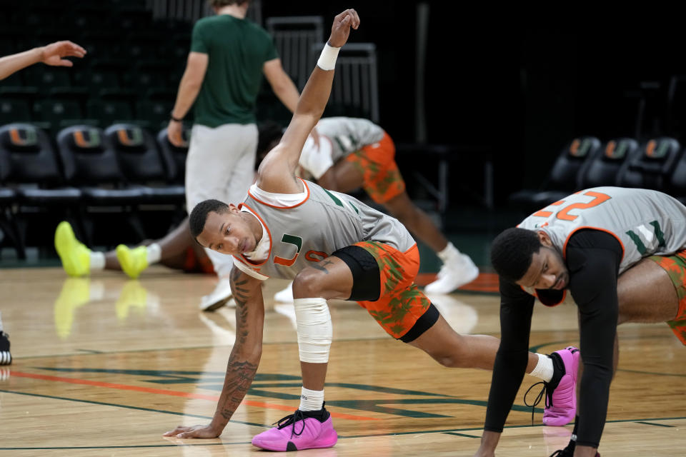 Miami's Matthew Cleveland stretches during practice at media day for the Miami NCAA college basketball team, Monday, Oct. 23, 2023, in Coral Gables, Fla. (AP Photo/Lynne Sladky)