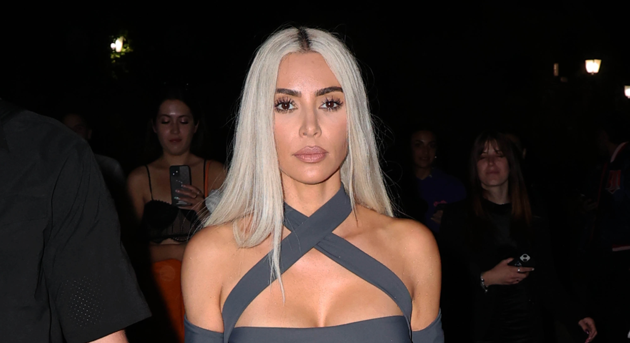 Kim Kardashian revealed she had gone back through her wardrobe for the all-black outfit she wore to sister Kourtney's wedding. (Getty Images)