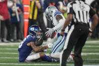 New York Giants' Isaiah Hodgins, left, fumbles the ball during the second half of an NFL football game against the Dallas Cowboys, Sunday, Sept. 10, 2023, in East Rutherford, N.J. (AP Photo/Bryan Woolston)