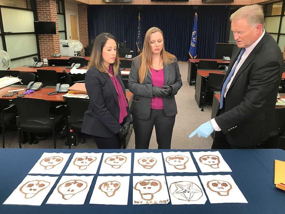 Skulls, drawn by serial killer Israel Keyes in his own blood, were found under his bed in his jail cell. The FBI is making them public for the first time. It is believed Keyes killed 11 people, as represented by the 11 skulls. From left, FBI Special Agents Katherine Nelson and Jolene Goeden with 