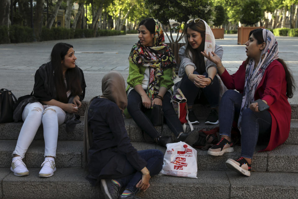 In this Saturday, May 18, 2019 photo, a group of students spend time together after classes in downtown Tehran, Iran. (AP Photo/Vahid Salemi)