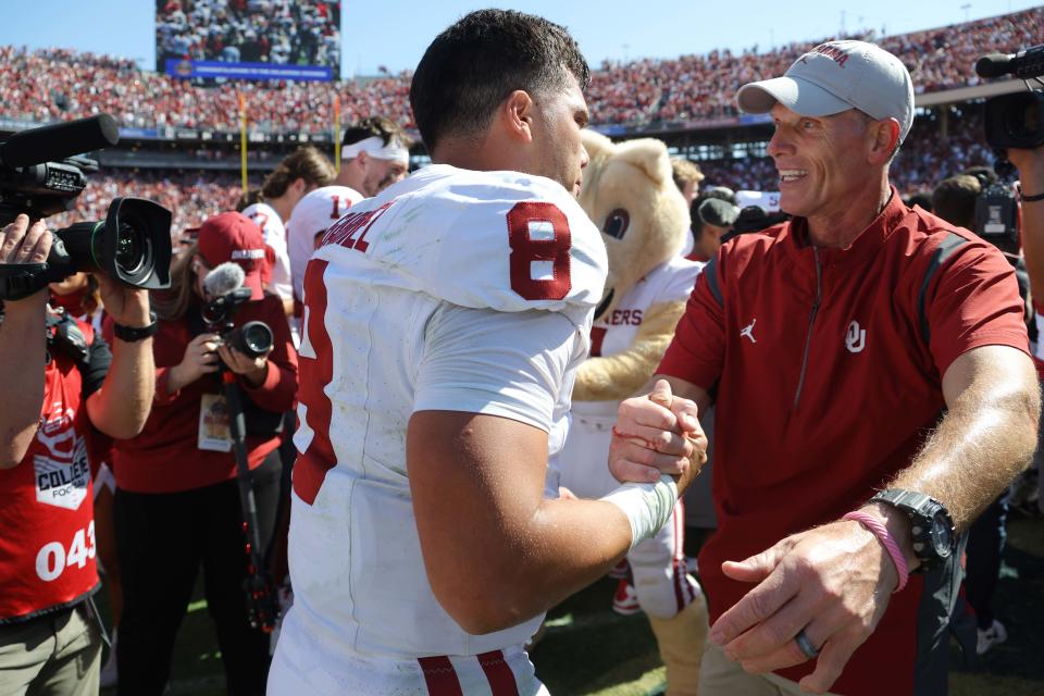 Oklahoma Sooners quarterback Dillon Gabriel (8) celebrates with OU coach Brent Venables after the Red River Rivalry college football game between the University of Oklahoma Sooners (OU) and the University of Texas (UT) Longhorns at the Cotton Bowl in Dallas, Saturday, Oct. 7, 2023. Oklahoma won 34-30.