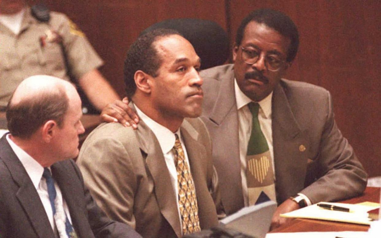 Real-life drama: OJ Simpson (centre) and lawyer Johnnie Cochran (right) during the trial in 1995 - POOL/AFP/Getty