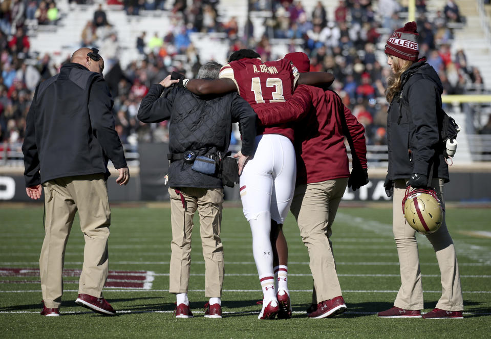 Boston College quarterback Anthony Brown is helped off the field after getting injured against North Carolina State Saturday, Nov. 11, 2017, in Boston. (AP Photo/Mary Schwalm)