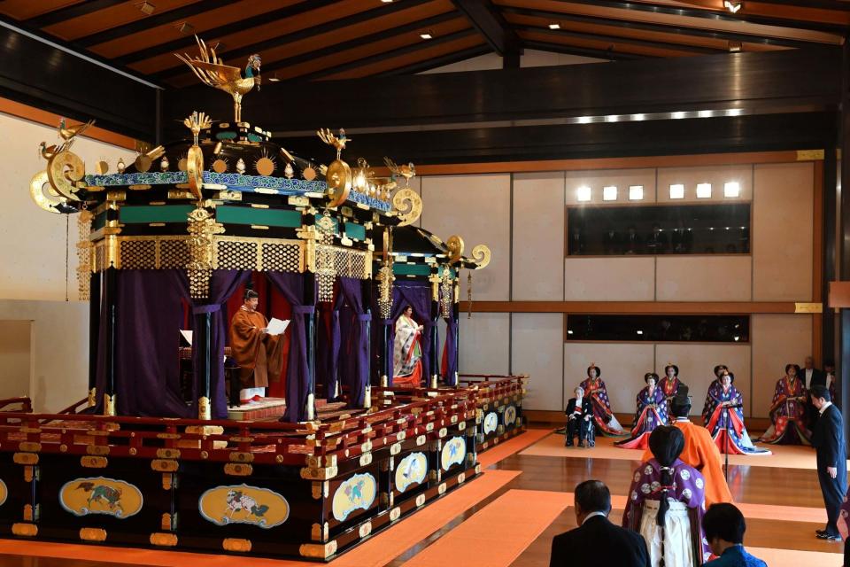 (AP) Emperor Naruhito, left, delivers his speech as Empress Masako, second from left, Prime Minister Shinzo Abe, right, and other officials attend the enthronement ceremony