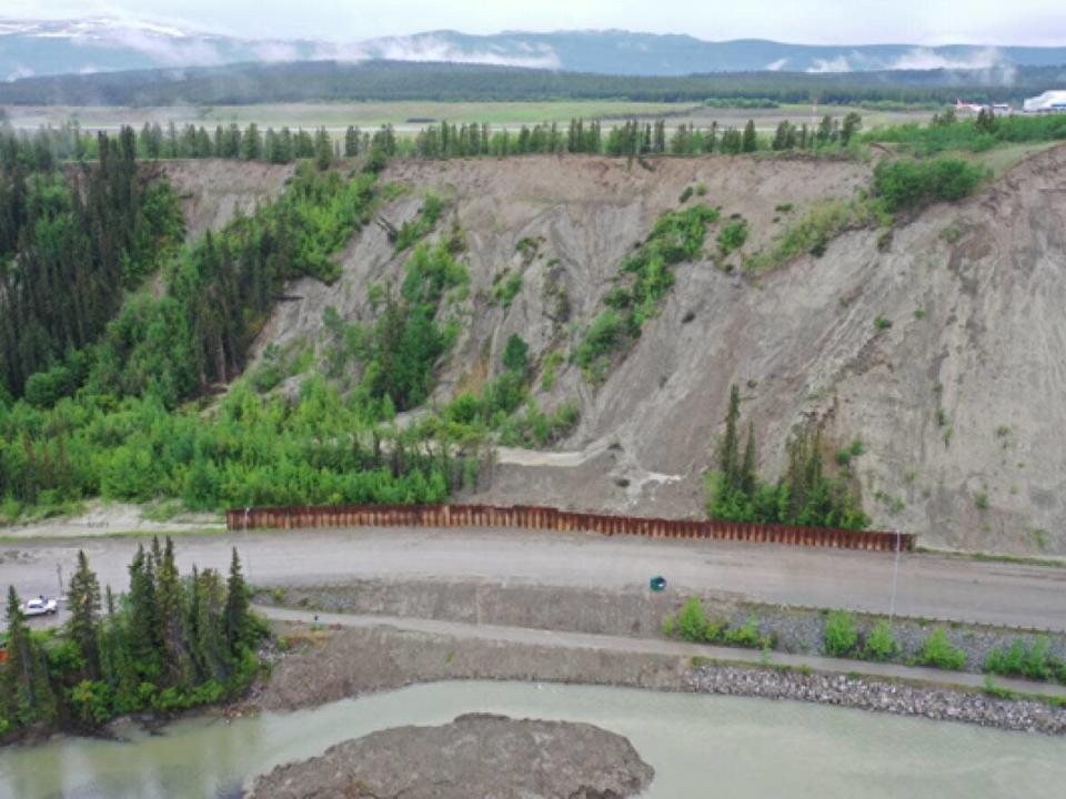 A sheet pile wall, built to mitigate the damage from any future potential landslide, has been built alongside Robert Service Way in Whitehorse. The city said it is finishing strengthening the wall with an earth berm, which should be 'finished soon.' (Submitted by City of Whitehorse - image credit)