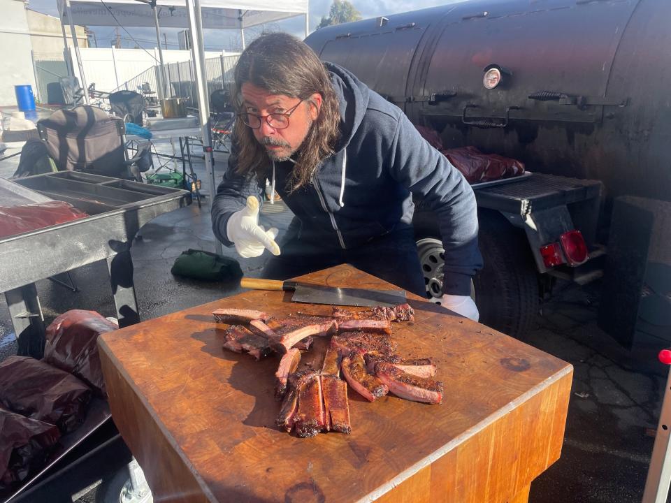 Rocker Dave Grohl and friends brought his giant smoker and cooked/fed barbecue and sides for 500 folks at Hope Mission in L.A. during the storms