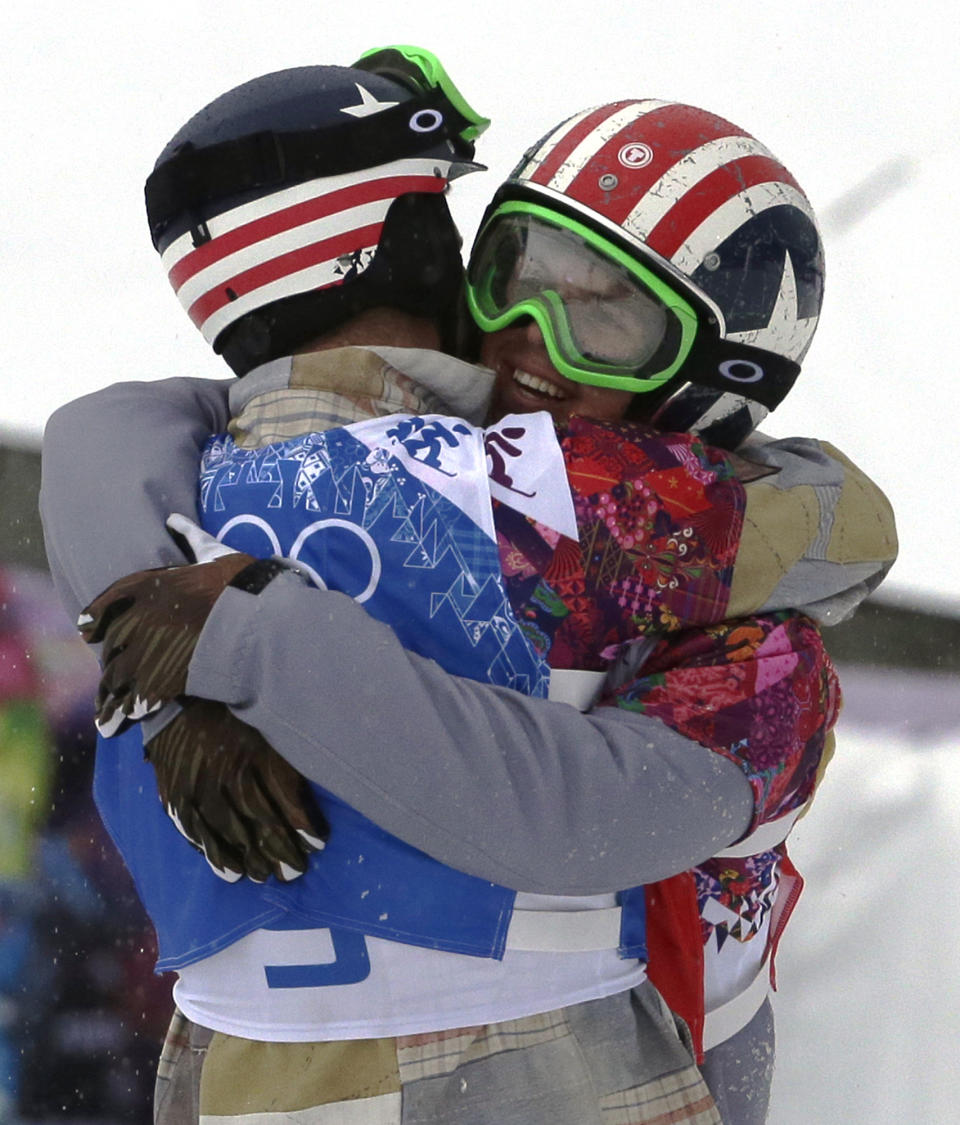 Alex Deibold of the United States, left, embraces Trevor Jacob of the United States after the men's snowboard cross semifinal at the Rosa Khutor Extreme Park, at the 2014 Winter Olympics, Tuesday, Feb. 18, 2014, in Krasnaya Polyana, Russia. (AP Photo/Andy Wong)