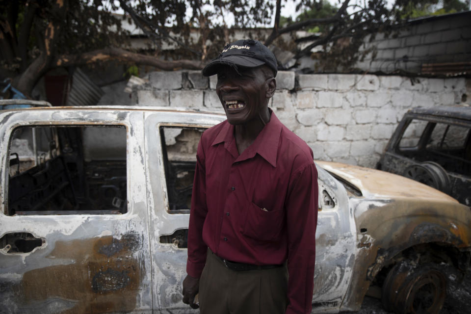 Jean Claude Celestin recalls how his car was set on fire during clashes between armed gangs in the Butte Boyer neighborhood of Port-au-Prince, Haiti, Friday, May 13, 2022. Gangs are fighting each other and seizing territory in the capital of Port-au-Prince with a new intensity and brutality in a country that many feel is swiftly unraveling as it tries to recover from the July 7 assassination of President Jovenel Moïse. (AP Photo/Odelyn Joseph)