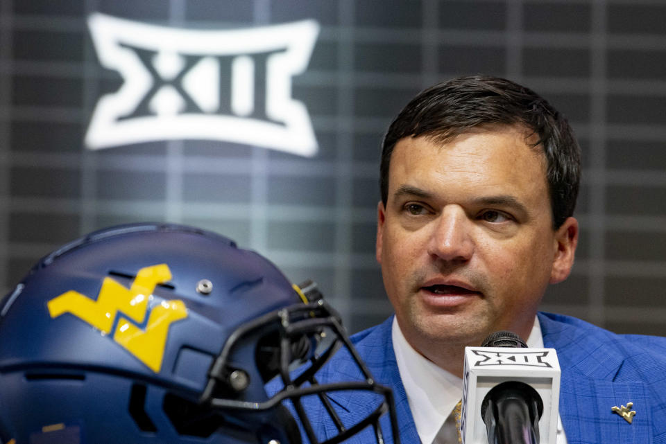 FILE - West Virginia head football coach Neal Brown answers questions from reporters at the NCAA college football Big 12 media days in Arlington, Texas, Thursday, July 13, 2023. West Virginia has a brutal early schedule with nonconference games against No. 7 Penn State and Pitt and conference games against Texas Tech and No. 17 TCU before October. (AP Photo/Emil T. Lippe, File)