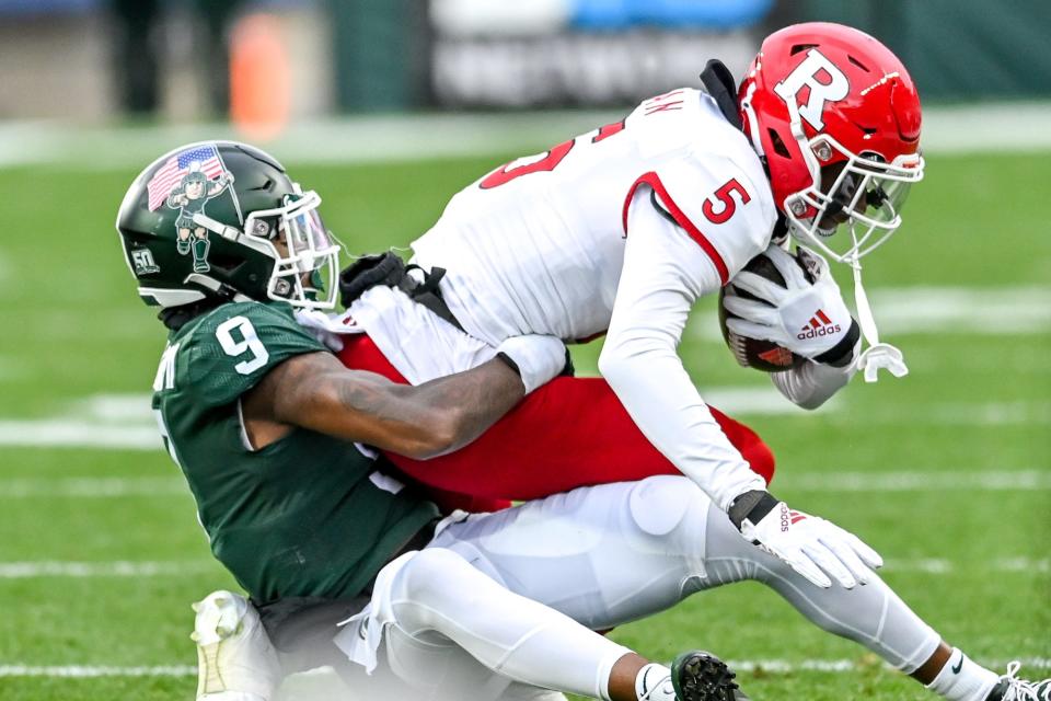 Michigan State's Ronald Williams, left, tackles Rutgers' Sean Ryan during the first quarter on Saturday, Nov. 12, 2022, in East Lansing.