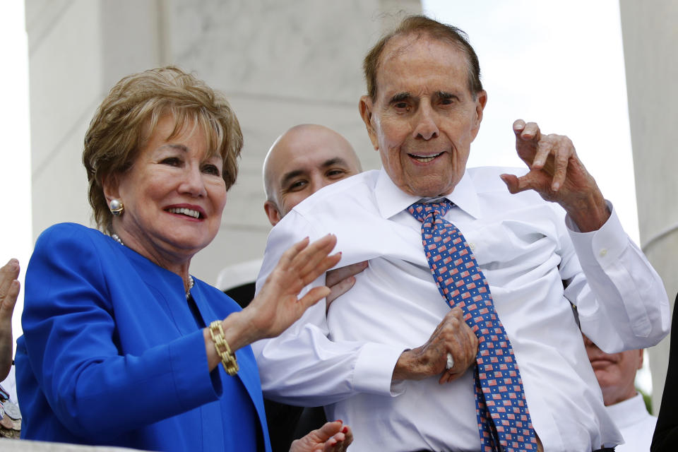 FILE - In this May 27, 2019 file photo, former Sen. Bob Dole, right, and his wife Elizabeth Dole acknowledge well-wishers during a Memorial Day ceremony, at Arlington National Cemetery in Arlington, Va. The political icon and 1996 Republican presidential nominee on Monday, Jan. 13, 2020, endorsed western Kansas' congressman Rep. Roger Marshall in the state's GOP Senate primary. Marshall's campaign announced Dole's backing and Dole tweeted that Marshall is "a true friend to KS." Marshall has served in Congress since 2017. (AP Photo/Patrick Semansky File)