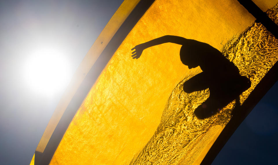 <p>A visitor enjoys a water slide in Hanover, Germany, Aug. 24, 2016. (Photo: JULIAN STRATENSCHULTE/EPA) </p>