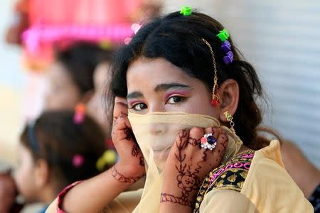 An Iraqi girl is seen as she celebrates Eid al-Fitr, in Mosul, Iraq June 25, 2017. REUTERS/Alaa Al-Marjani