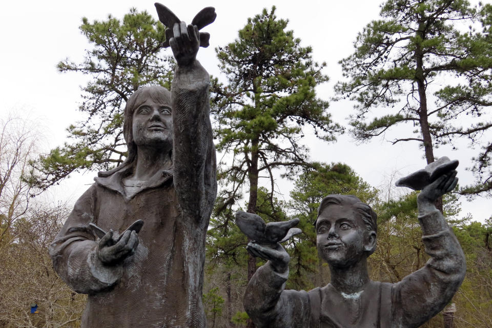 A sculpture stands a memorial garden for children who died from any cause, Feb. 21, 2023 in Toms River, N.J. Many residents of Toms River, where the former Ciba-Geigy chemical plant dumped toxic waste into the Toms River and directly onto the ground, oppose a settlement with the site's current owner, BASF Corp. to restore natural resources at the site as inadequate and ill-advised. (AP Photo/Wayne Parry)