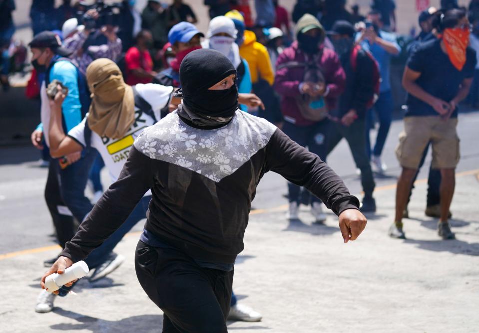 Sept. 23, 2022: Demonstrators protesting the disappearance of 43 college students throw explosive devices toward soldiers and police during a protest outside of a military base in Mexico City, Friday, Sept. 23, 2022, days before the anniversary of the disappearance of the students in Iguala, Guerrero in 2014. One week prior, Mexican authorities said they arrested a retired general and three other members of the army for alleged connection to their disappearance.