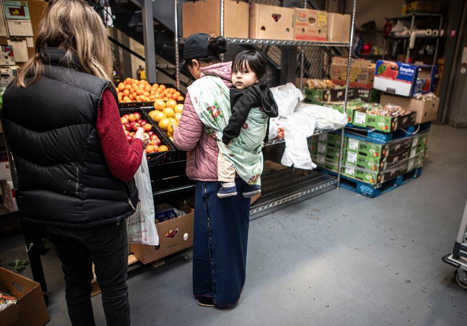 A mother chooses fresh produce at the People to People food pantry in Nanuet last month. Those facing chronic food insecurity can make monthly appointments to shop the food pantry for a 10-day supply of fresh produce and staples.