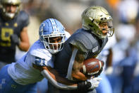 Georgia Tech's Tobias Oliver (8) runs with the ball as North Carolina linebacker Chazz Surratt (21) tackles during the first half of an NCAA college football game Saturday, Oct. 5, 2019, in Atlanta. (John Amis/Atlanta Journal-Constitution via AP)
