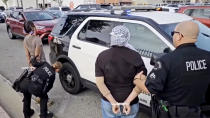 This video still image provided by KABC-TV shows protesters being arrested by Los Angeles police officers on Wednesday, Dec. 27, 2023, near Los Angeles International Airport. Pro-Palestinian protesters briefly blocked entrance roads to airports in New York and Los Angeles on Wednesday, forcing some travelers to set off on foot to bypass the jammed roadway. (KABC-TV via AP)