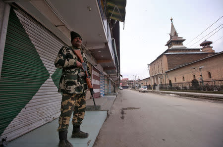 Indian Central Reserve Police Force (CRPF) personnel stands guard in front of closed shops next to the Jamai Masjid in Srinagar February 23, 2019. REUTERS/Danish Ismail