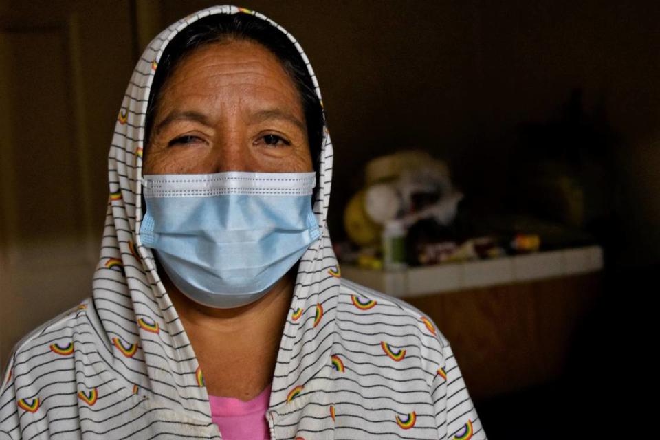 Maria Rios, 59, looks at the camera while in her Madera home on Wednesday, Jan. 18, 2023. She had to stop working in the fields because of a fractured foot, diabetes and kidney problems. She gets dialysis three times a week to make up for the work her kidneys can’t do, and the pain caused by the procedure made her a recurrent patient at the now-closed Madera Community Hospital.