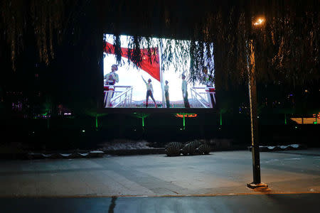 A large screen, which faces North Korea, broadcasts propaganda videos on an island on the Yalu River between North Korea and China, in the town of Linjiang in Jilin province, China, November 21, 2017. REUTERS/Damir Sagolj