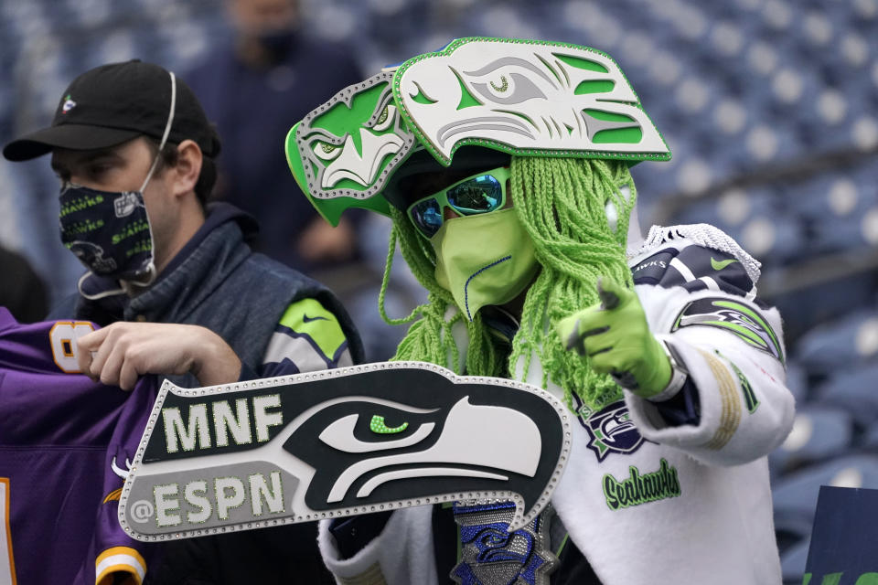 A Seattle Seahawks fans looks out from the stands before an NFL football game against the New Orleans Saints, Monday, Oct. 25, 2021, in Seattle. (AP Photo/Ted S. Warren)