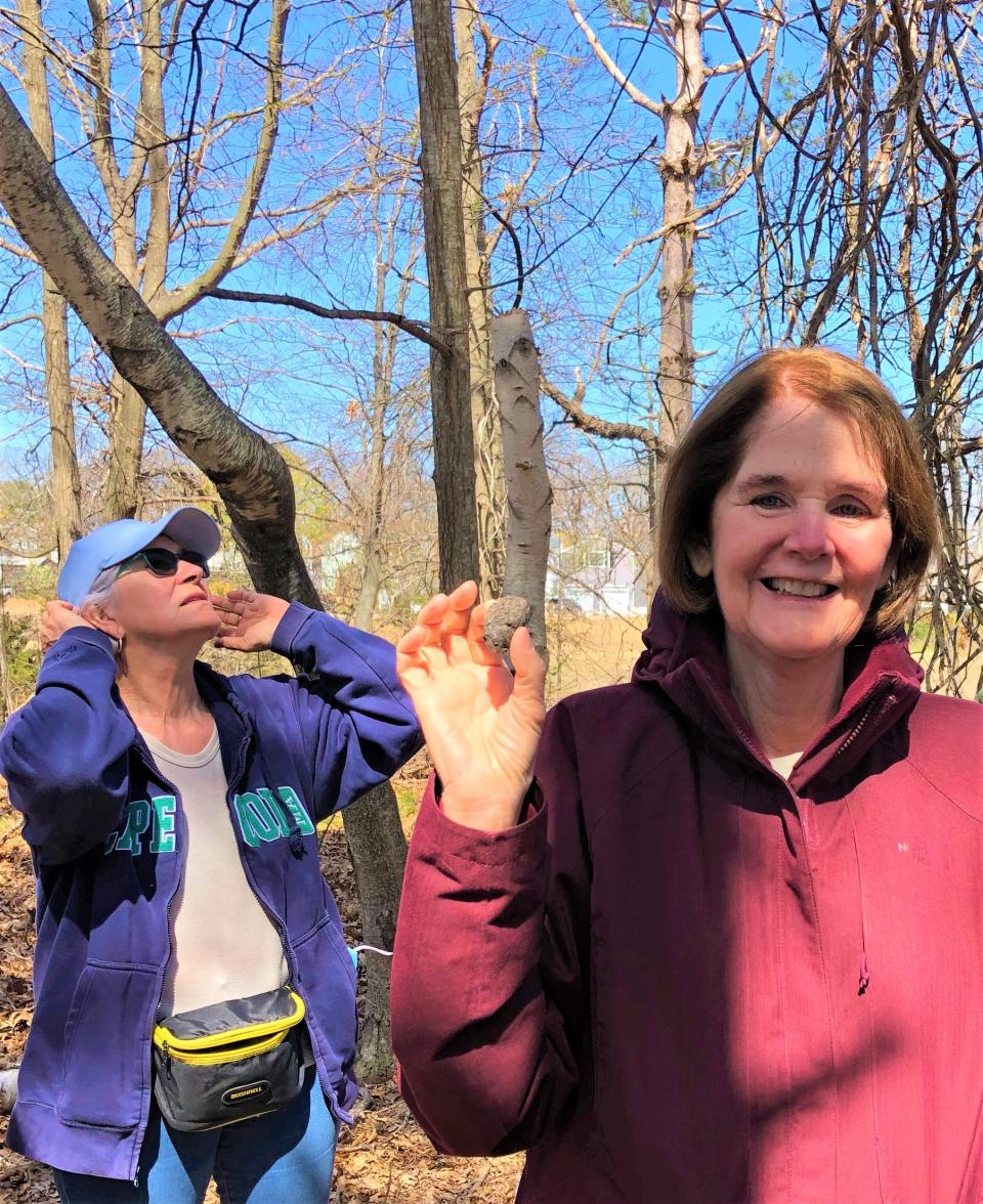 Joan Rodeck, right, holds an owl pellet on the Quincy Environmental Treasures tour Saturday, April 23, 2022. The owl regurgitates parts of animals it cannot digest.