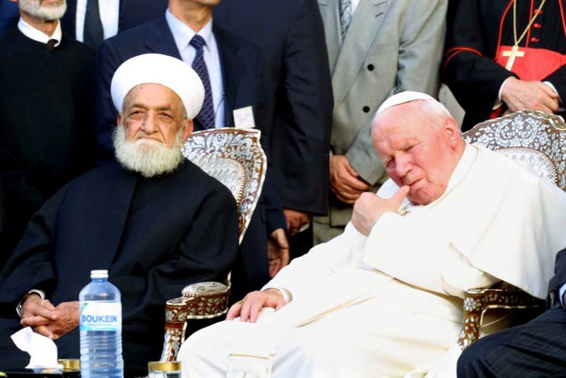 Syria's Mufti Sheikh Ahmad Kuftaro (L) meets Pope John Paul II at the Great Umayyad Mosque in Damascus' old city where the Tomb of Saint John Baptist is located May 6, 2001. Pope John Paul made history by becoming the first pontiff ever to enter a mosque and urged Christians and Muslims to forgive each other for the past. File Photo by Khaledal-Hariri/UPI