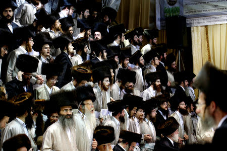 Ultra-Orthodox Jewish men take part in the celebrations of Simchat Torah in a synagogue at the Mea Shearim neighbourhood of Jerusalem October 1 , 2018. REUTERS/Ronen Zvulun